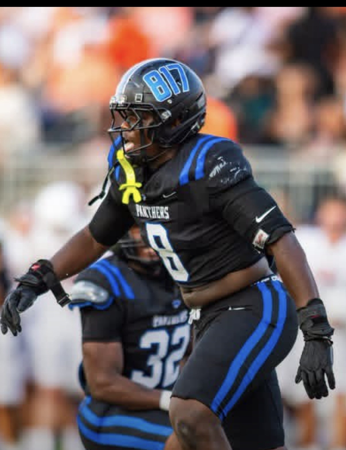 North Crowley defensive lineman in a black Panthers jersey number 8 rushing off the edge