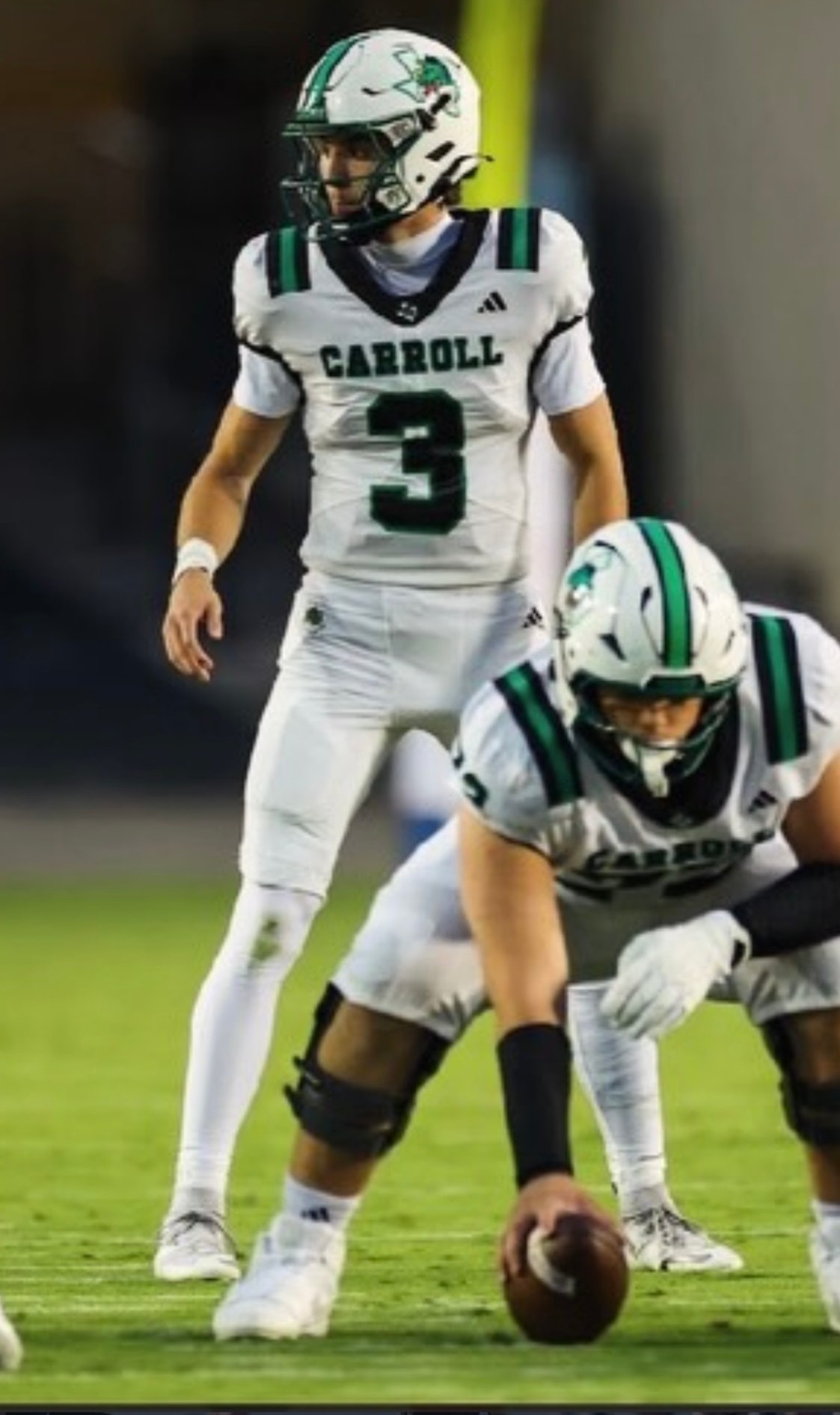 Southlake Carroll quarterback Hudson Tomcheck in a white number 3 jersey surveying the defense before the snap